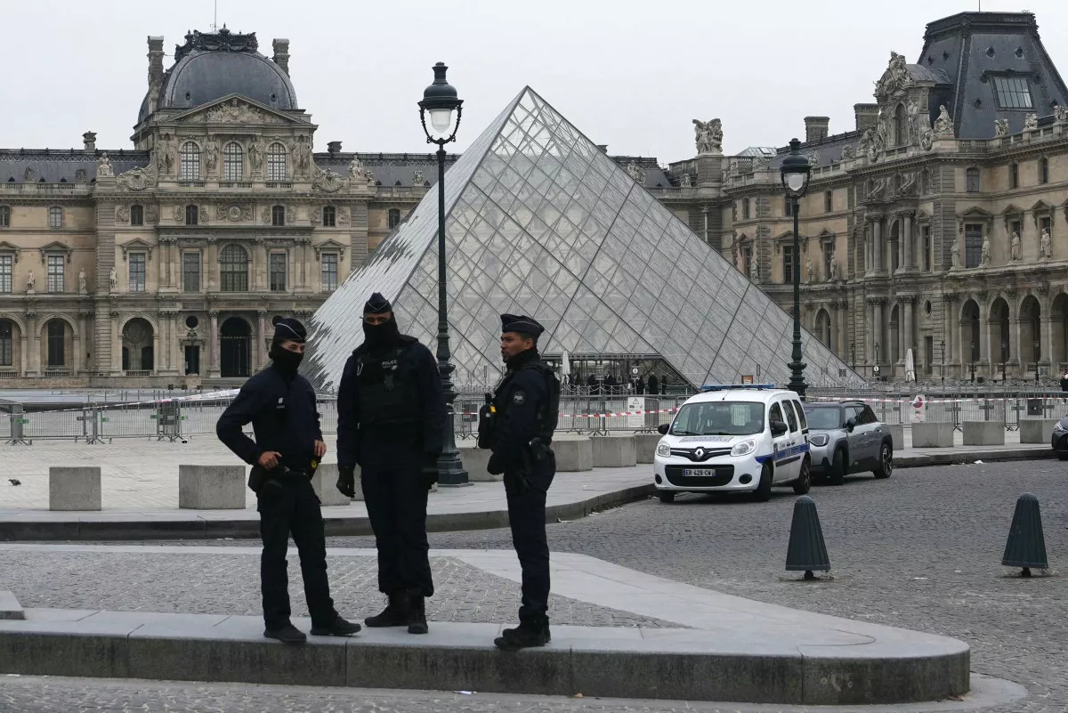 Agentes de policía franceses se paran frente al Museo del Louvre después del robo, en París el 19 de octubre de 2025.