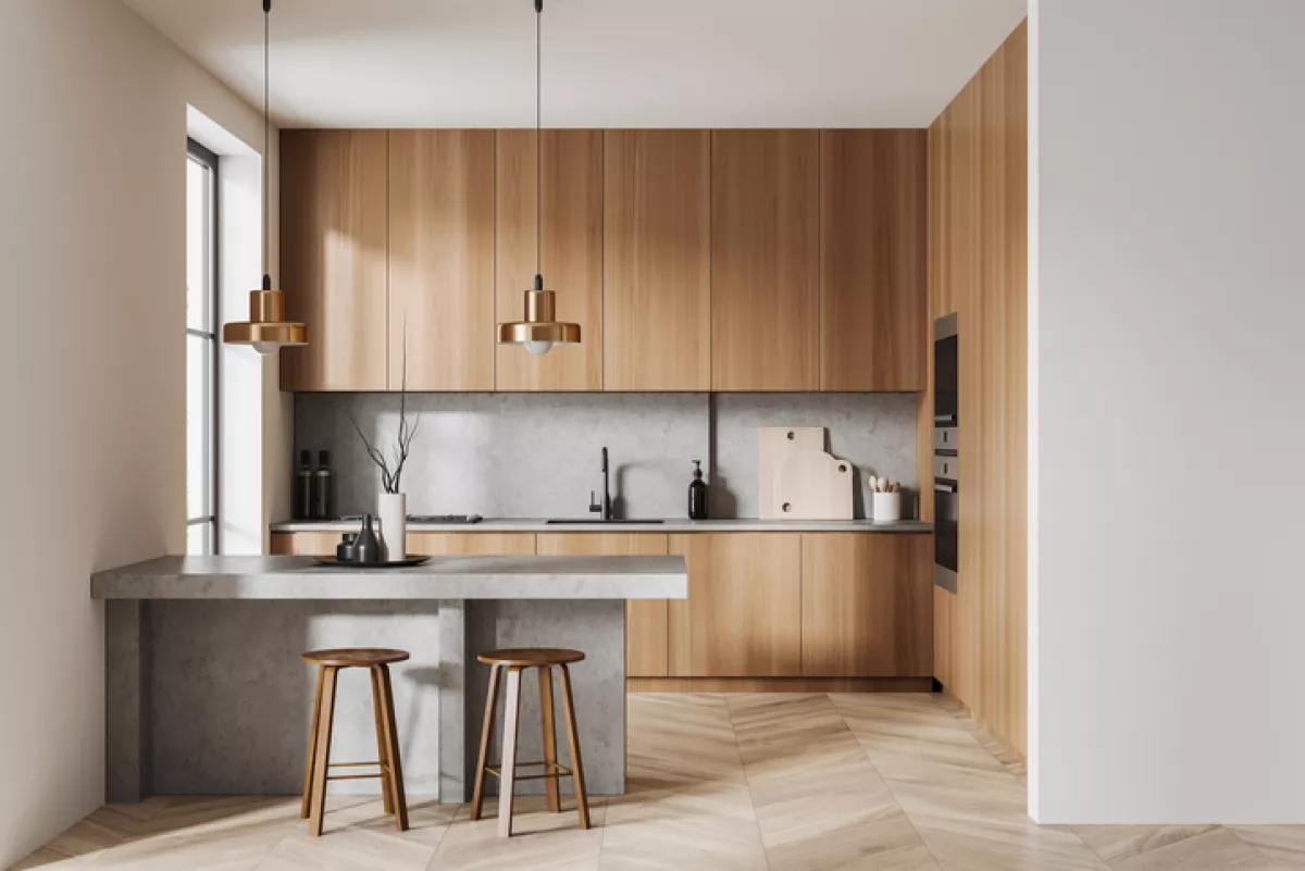 Light kitchen interior with bar countertop and seats, cooking zone