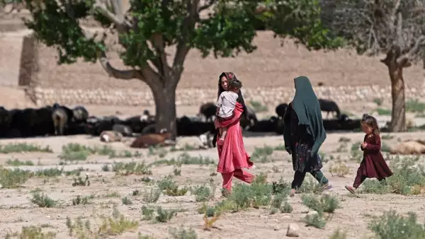 En esta foto tomada el 4 de junio de 2023, las mujeres caminan con sus hijos en el pueblo de Kandali en el distrito de Sholgara de la provincia de Balkh.