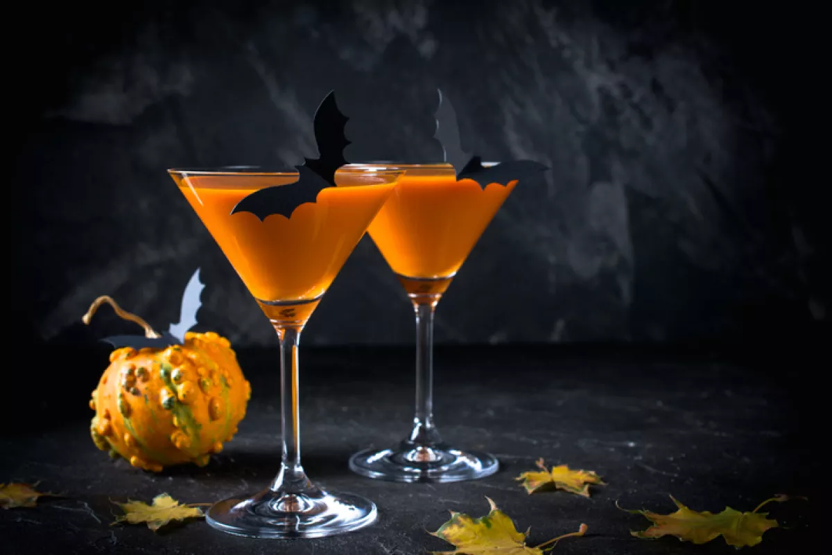 Halloween pumpkin orange cocktails. Festive drink. Halloween party. Funny Pumpkin with holiday decorations