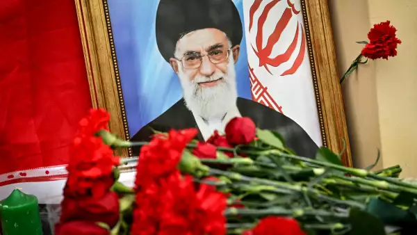 This photograph shows flowers laid at a makeshift altar with a portrait of late Iran's supreme leader Ayatollah Ali Khamenei and a flag of the Islamic Republic of Iran outside the Iranian Embassy in Russia, in Moscow on March 2, 2026. Russian President on March 1 slammed the United States and Israel's killing of Khamenei as a "cynical violation" of morality and law. Tehran has stood by as one of Russia's closest allies throughout Moscow's Ukraine offensive, and the Kremlin had earlier called for restraint in the run-up to the US-Israeli strikes on Iran. 