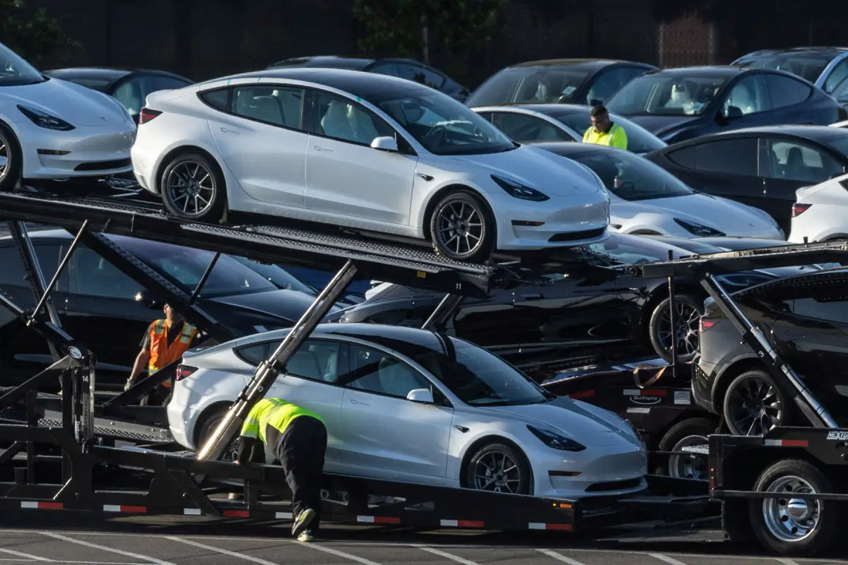 FILE PHOTO: Tesla Model 3 vehicles are seen for sale at a Tesla facility in Fremont, California