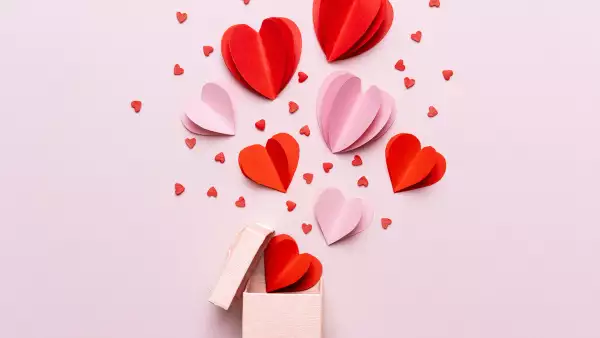 Valentine day composition with gift box and red hearts, photo template on pink background.