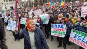 Con carteles, la gente participa en una protesta contra el gobierno moldavo y su presidente pro-UE en Chisinau el 19 de febrero de 2023.