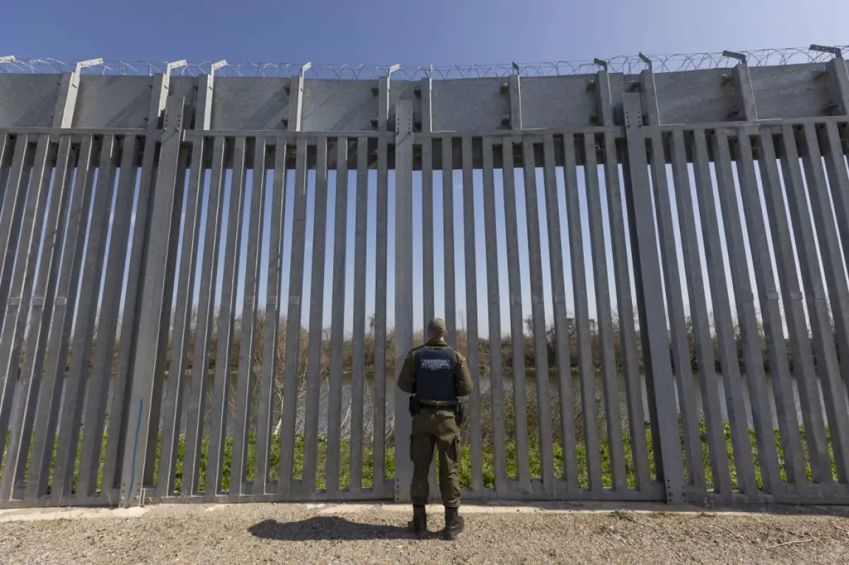 Los agentes de la policía fronteriza se paran frente a la valla en busca de entradas ilegales. Agentes de la policía fronteriza griega patrullan a lo largo de la valla de acero junto al río Evros entre Grecia y Turquía para evitar la entrada ilegal no autorizada de inmigrantes.