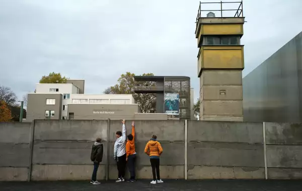 People visit remains of the Berlin Wall at the Wall memorial on Bernauer Strasse in Berlin