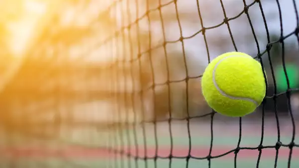 Tennis ball hitting to net on blur court background