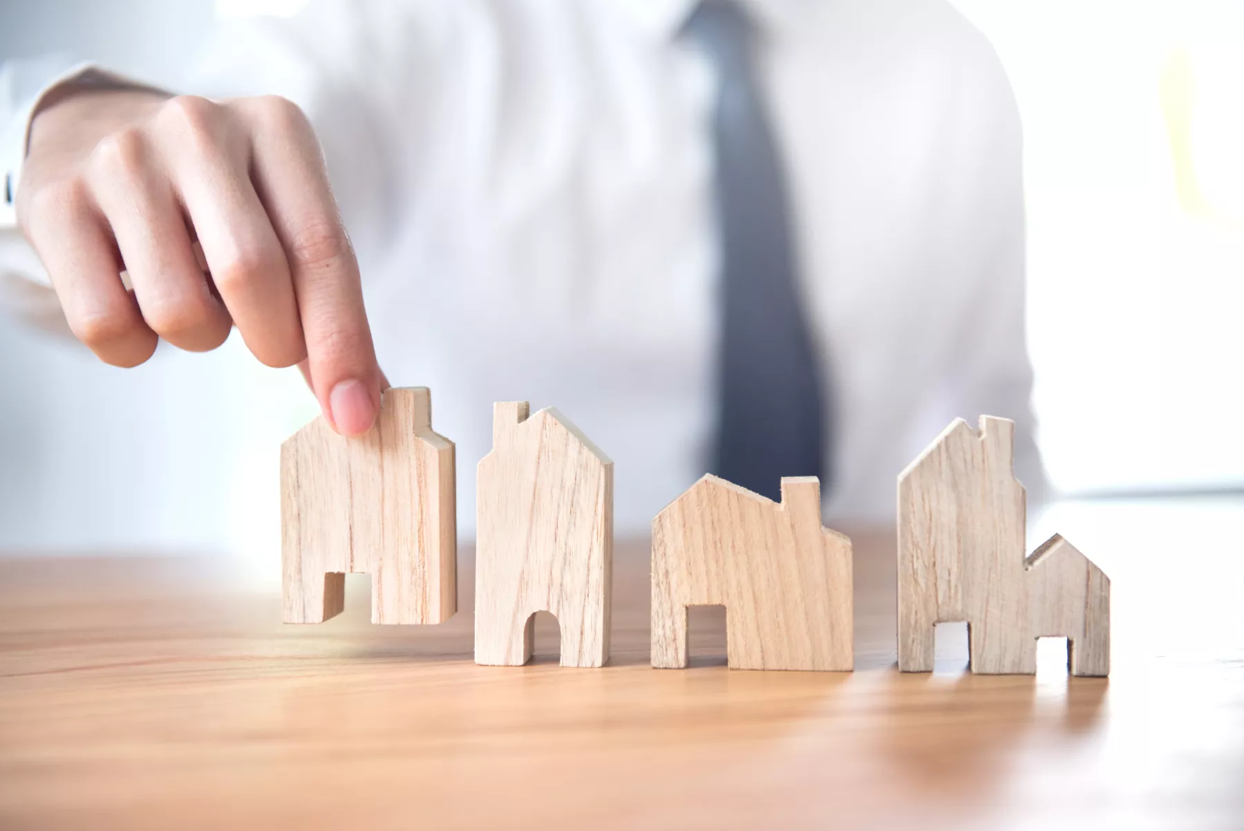 Hand of businessman choosing house model, Planning buy Real Estate.