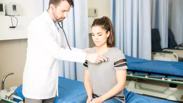 Doctor examining female patient
