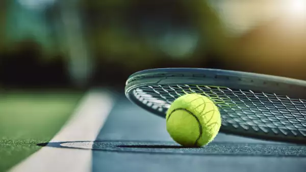 Tennis ball, racket and court ground with mockup space, blurred background or outdoor sunshine. 