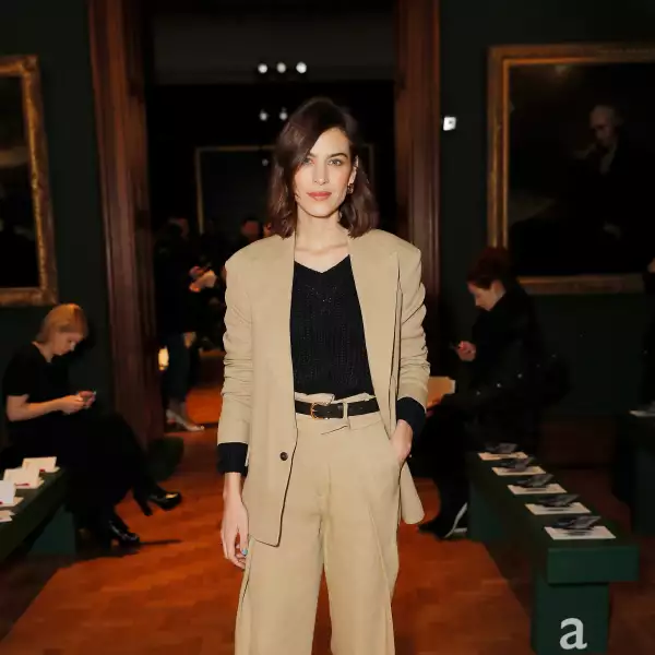 Alexa Chung en un look total beige de H&M Studio y unas sandalias Chanel para asistir al desfile de Erdem en London Fashion Week 2019