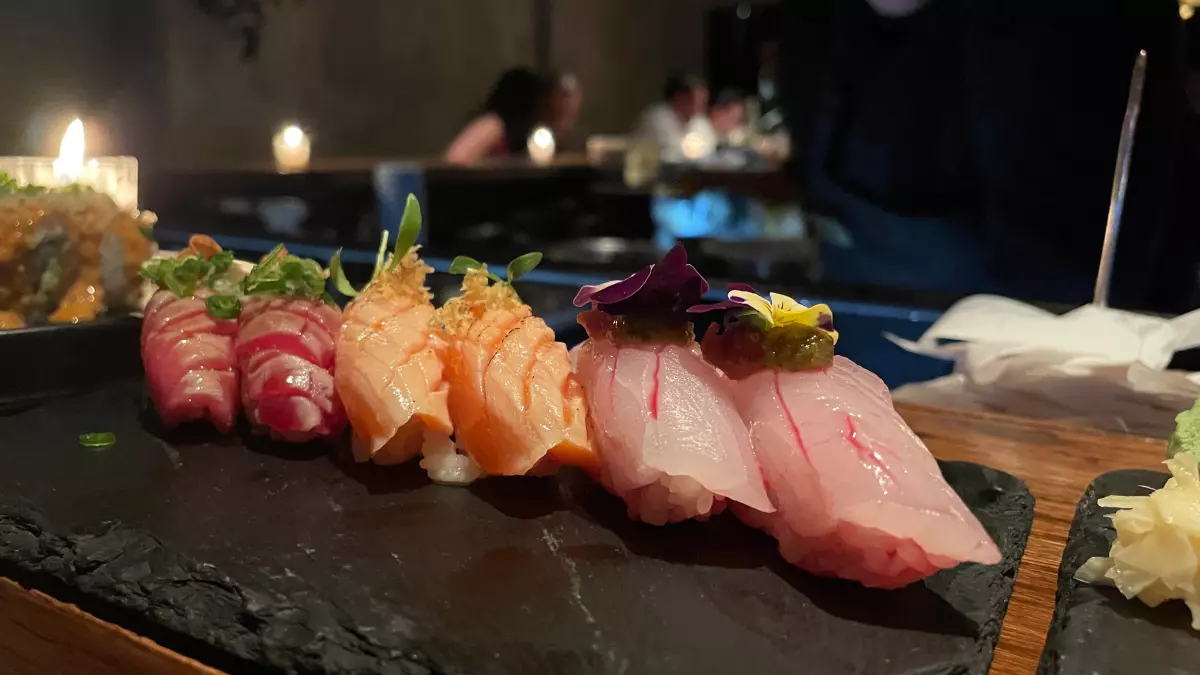 Foto de tres tipos de nigiris: salmón, robalo, atún.