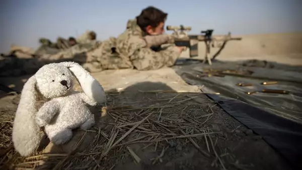 A German Bundeswehr army paratrooper sniper of the Task Force Kunduz opens fire next to a mascot during a drill in Kunduz, northern Afghanistan, December 8, 2010.  