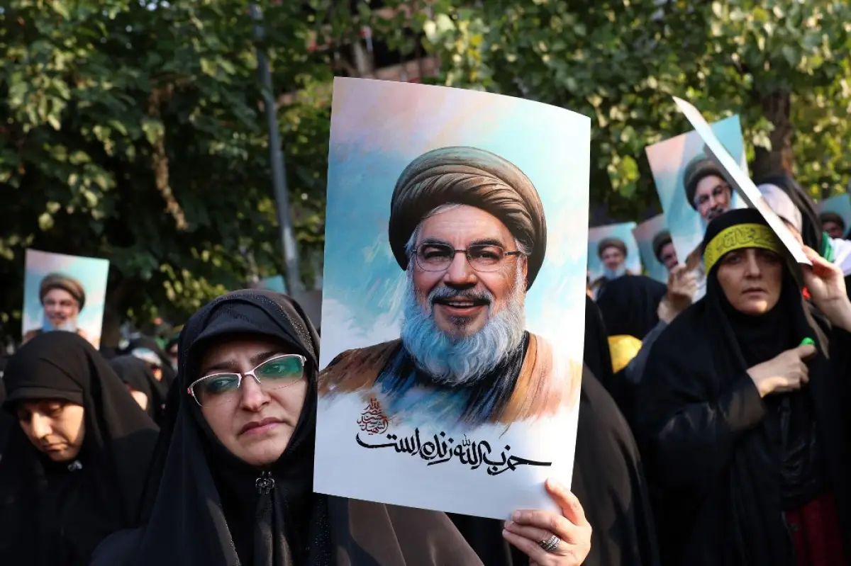 Mujeres iraníes sostienen fotos del líder de Hezbolá Hassan Nasrallah, que murió en un ataque aéreo israelí en los suburbios del sur de Beirut el 27 de septiembre, durante una protesta contra Israel en la Plaza de Palestina en Teherán el 30 de septiembre de 2024.