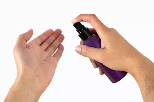 men’s hand using lotion
