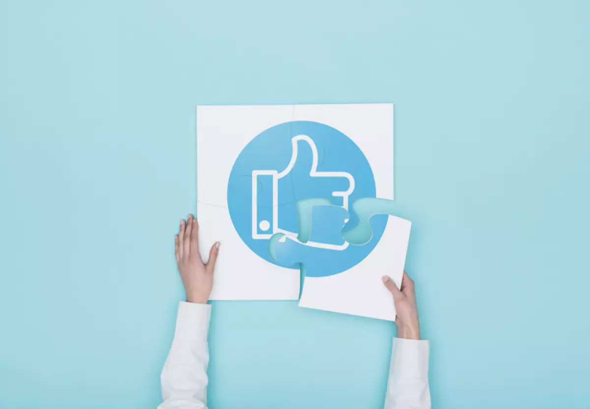 Woman completing a puzzle with thumbs up icon