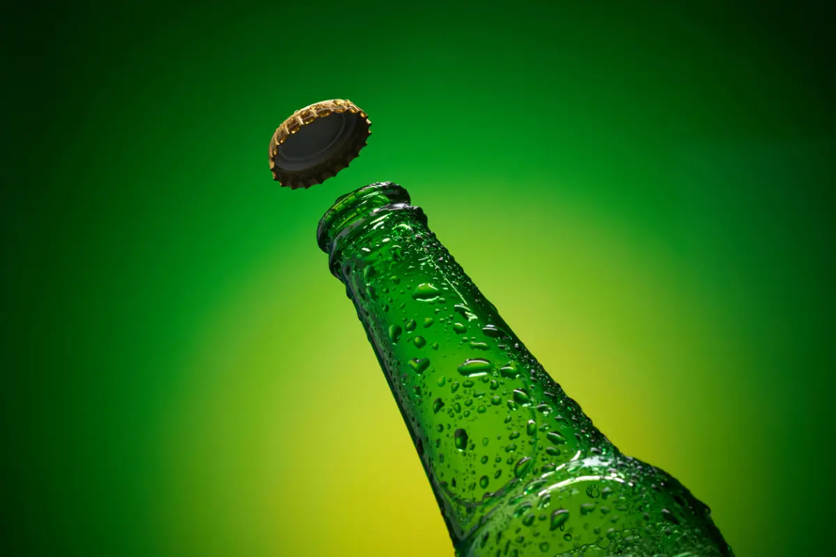 Ice cold beer with flying cap, stock photo