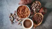 Top view of Cocoa drink, Natural cocoa powder with brown cocoa beans and cacao pod on a gray background