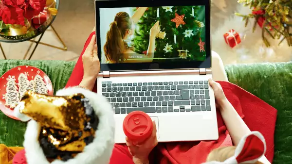 modern mother and child watching Christmas movie on laptop