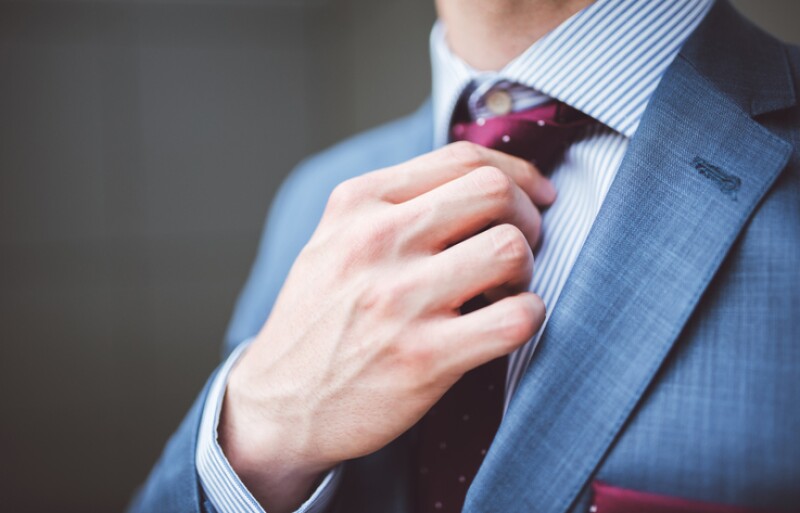 Businessman fixing his tie