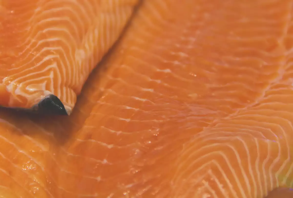 Raw pink salmon fillet at a market stall.