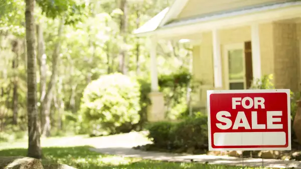 Home for sale with real estate sign.