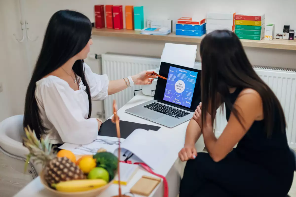Professional nutritionist explaining the nutritive values of each types of food, on the slide show, before she present the meal plan to her client