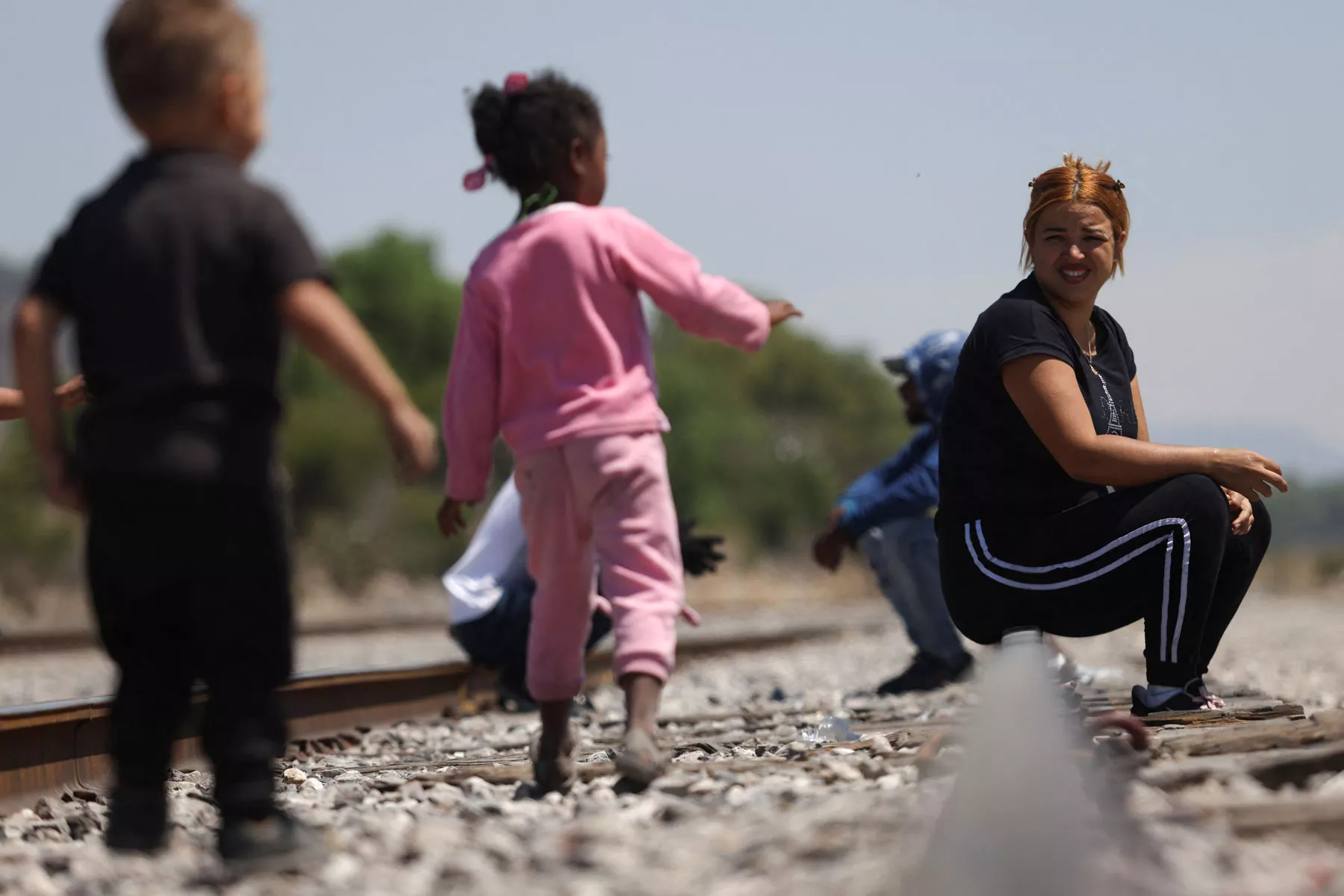 Migrants get on a train to continue their journey to U.S. in Huehuetoca