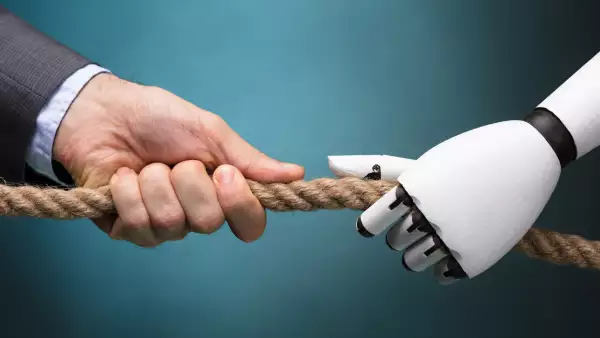 Businessperson And Robot Playing Tug Of War