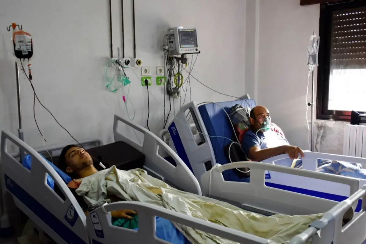 Esta foto de cortesía publicada por la Agencia Oficial de Noticias Árabe Siria (SANA) el 5 de octubre de 2023, muestra a personas heridas en el ataque con aviones no tripulados dirigido a una academia militar siria que recibe tratamiento médico en un hospital de Homs controlado por el gobierno.