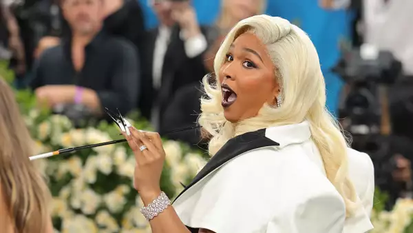 Foto de Lizzo a la llegada de la MET Gala 2025 con cabello rubio y labios pintados de negro.