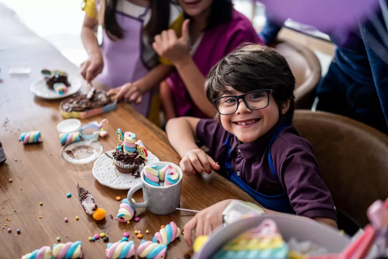Portrait of a boy playing with sweets on a children's day at home