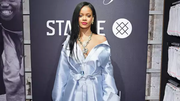 Rihanna usa un vestido azul claro con un gran collar de diamantes.