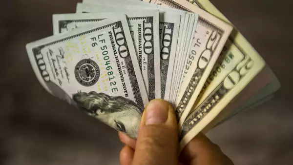 Unrecognizable mature man holding US Dollar bills