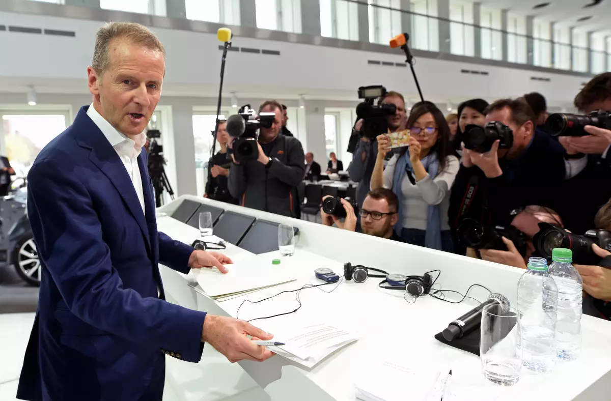 Herbert Diess, CEO of German carmaker Volkswagen is surrounded by media during the annual news conference at the Volkswagen plant in Wolfsburg