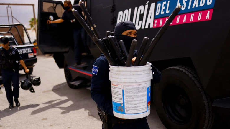 Security arrive to a prison following a fight between imprisoned members of rival gangs