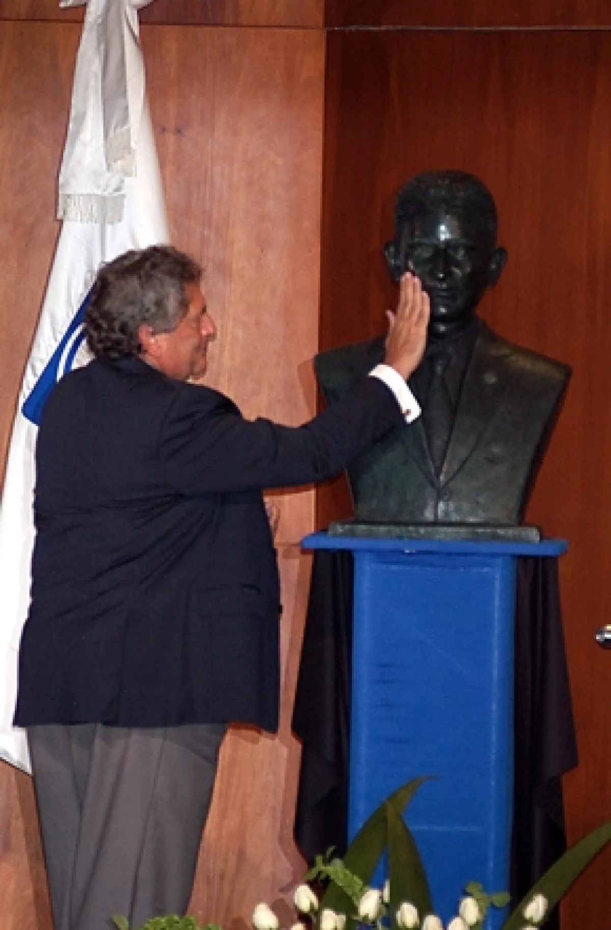 El padre de Mouriño acaricia el busto que fue develado.