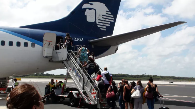 Aeromexico Passengers On Airstair Queuing In Line To Board Airplane At Cancun International Airport Mexico