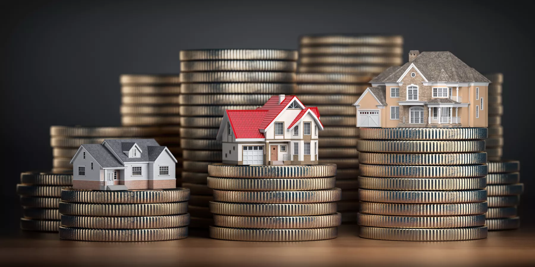 Houses of different size with different value on stacks of coins. Concept of  property, mortgage and real estate investment.
