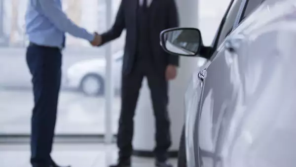 Handshaking in a car showroom