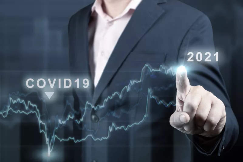 concept of economic recovery after the fall due to the covid 19 coronavirus pandemic. Financial graph 2021. Stock market chart. Businessman pointing graph. Return of growth after a fall