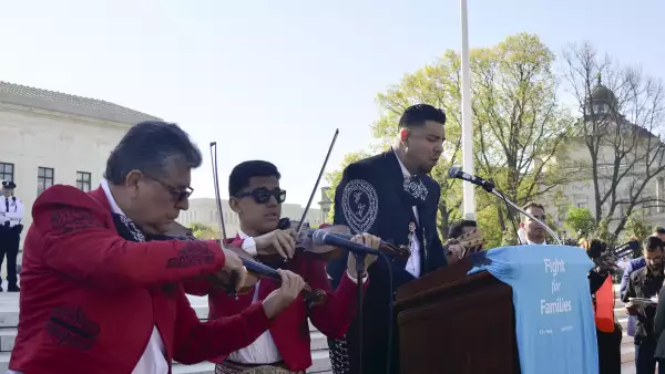 Jesús Ramos (derecha) entona el himno estadounidense frente a la Corte Suprema este lunes como parte de una manifestación para pedir leyes a favor de los inmigrantes.