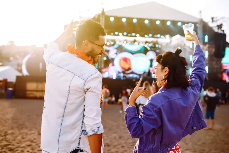 Couple with beer at music festival.