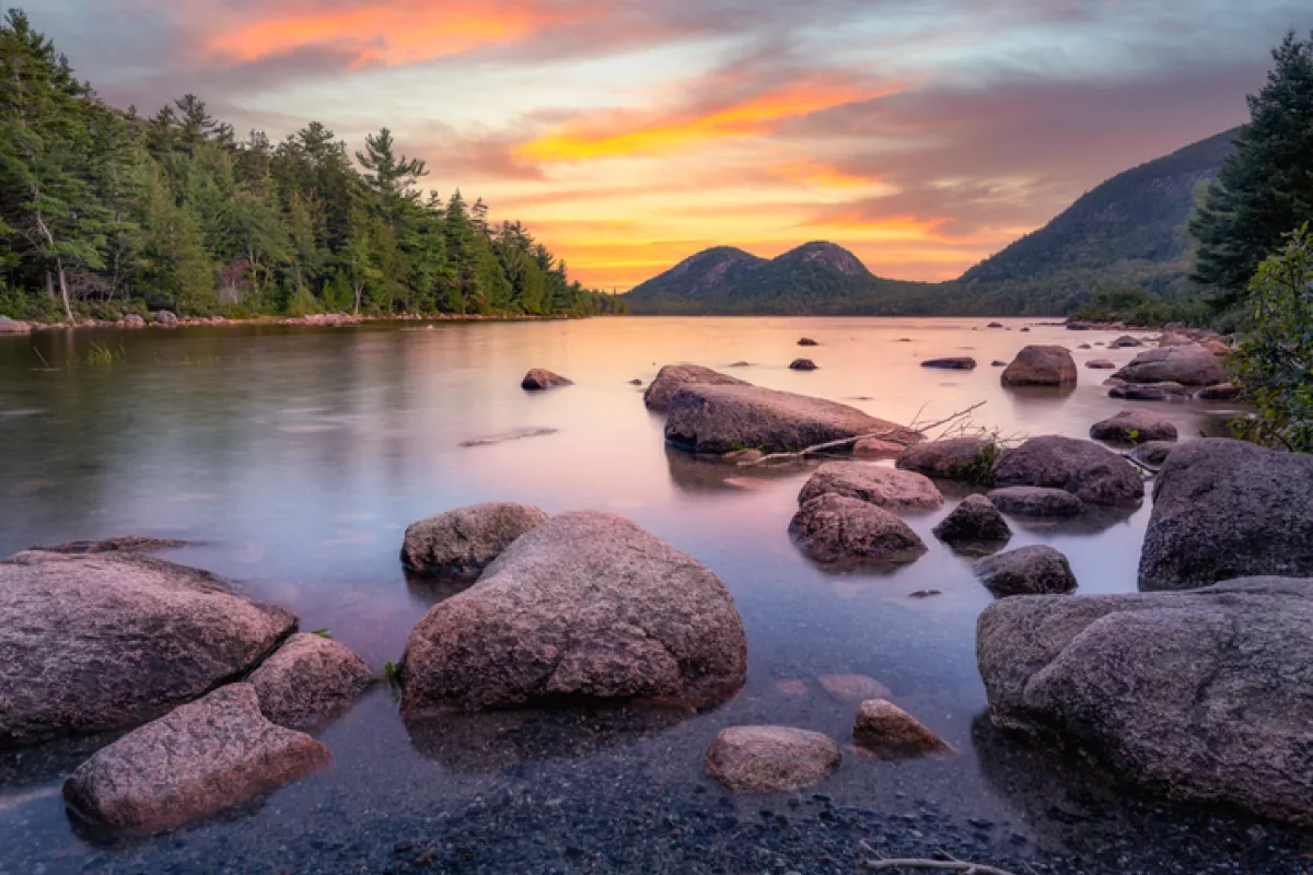 Vibrant dawn colors over Jordan Pond Maine