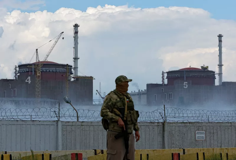 Un militar con una bandera rusa en su uniforme hace guardia cerca de la planta de energía nuclear de Zaporizhzhia en el curso del conflicto entre Ucrania y Rusia en las afueras de la ciudad de Enerhodar, controlada por Rusia, en la región de Zaporizhzhia, Ucrania, el 4 de agosto de 2022.