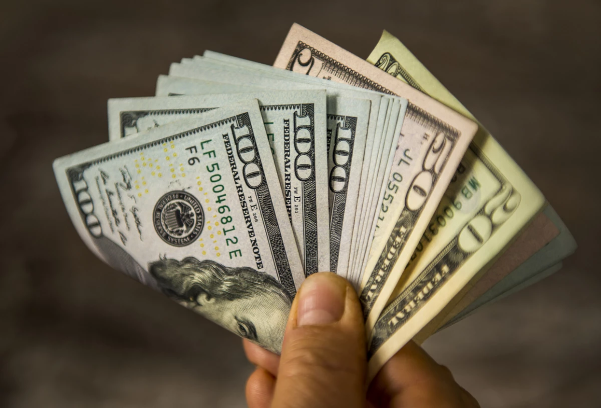 Unrecognizable mature man holding US Dollar bills