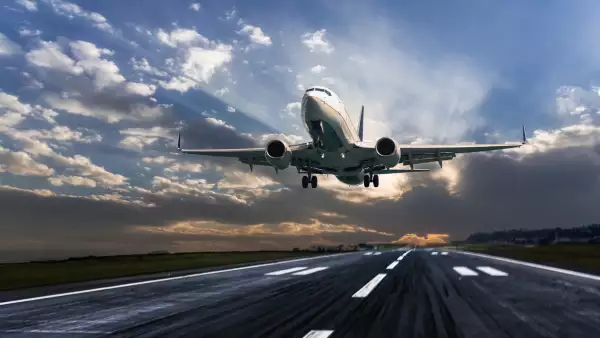 Passenger airplane landing at dusk