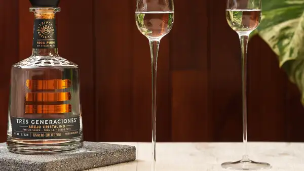 Botella de tres generaciones con copas servidas 
