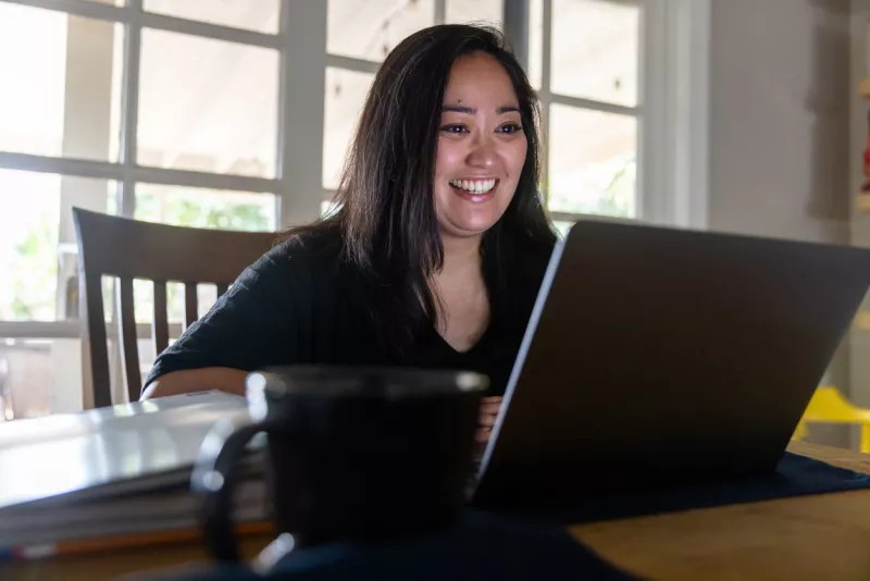 Young Asian Woman listening to Sales Pitch on Video Call