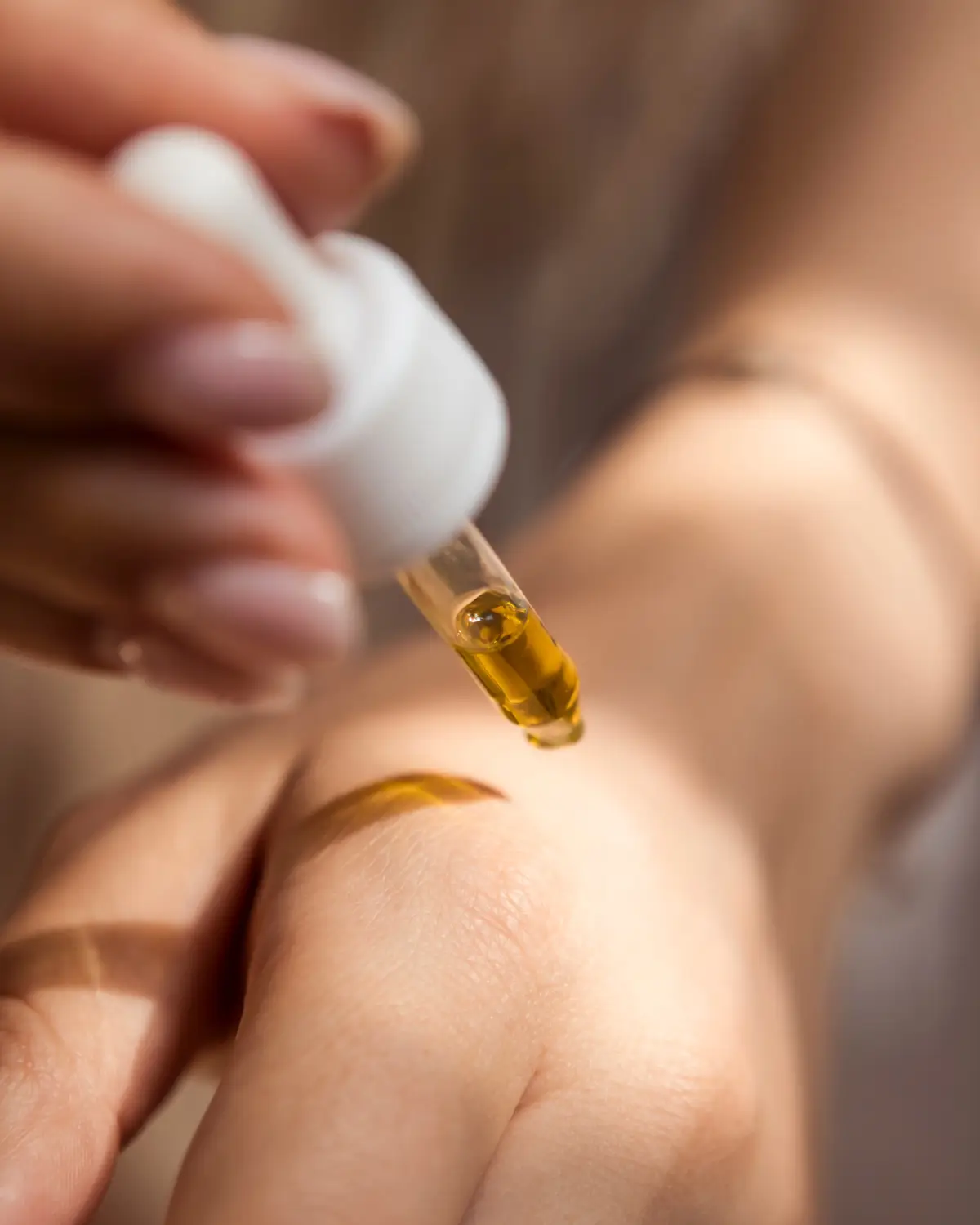 Persona aplicando un producto de belleza sobre la mano